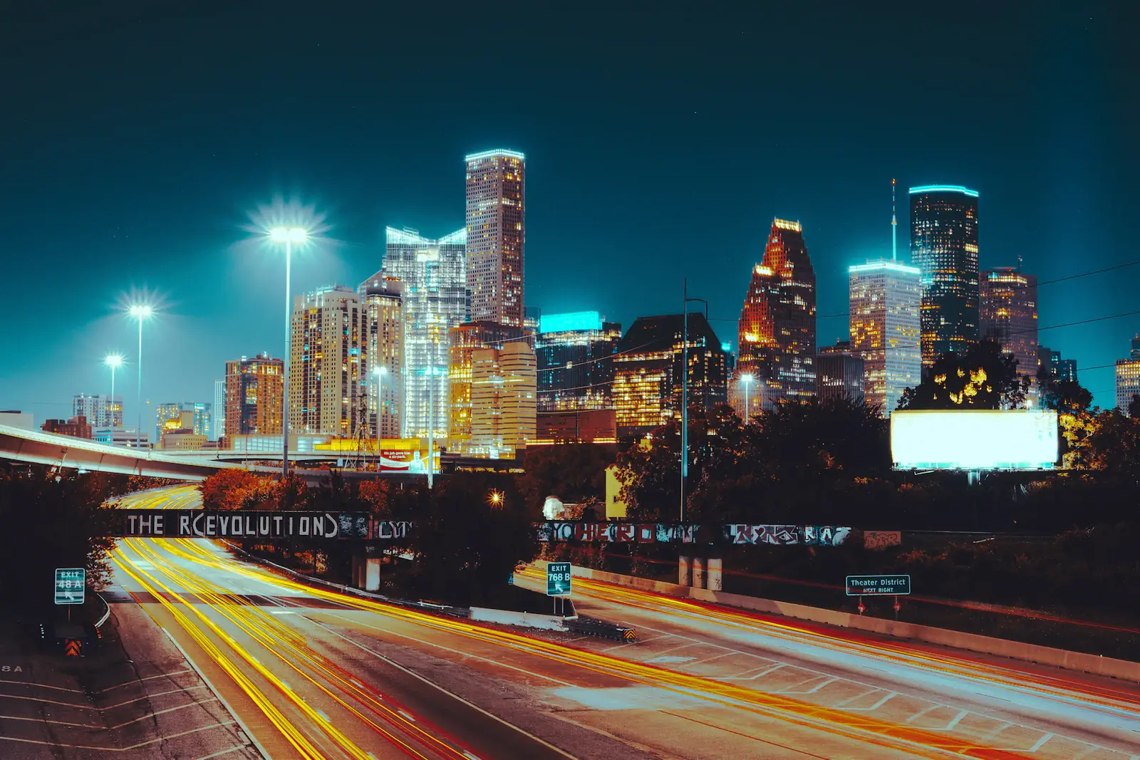 Houston skyline lit orange and blue at night