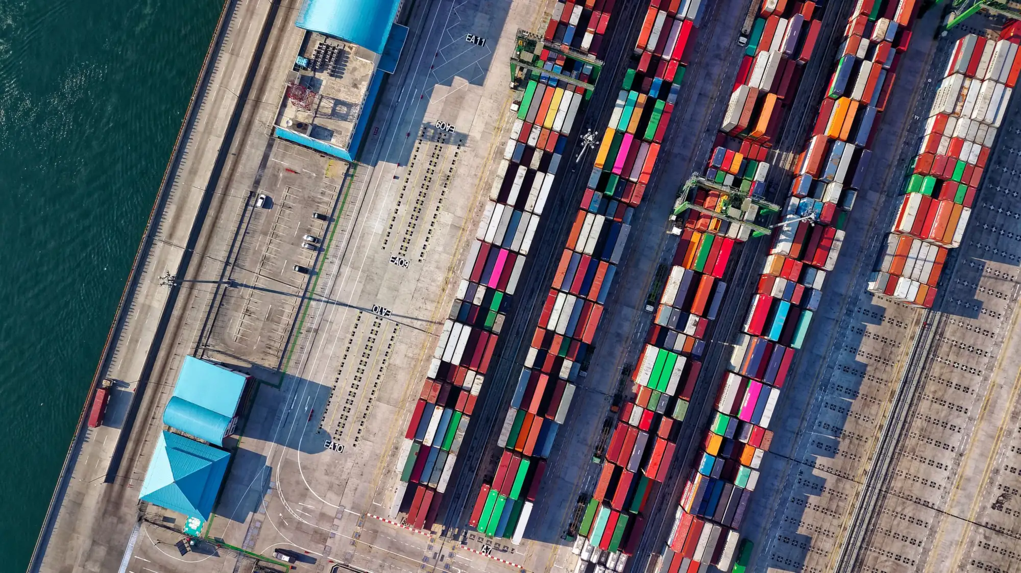 Aerial view of stacked shipping containers at a port terminal