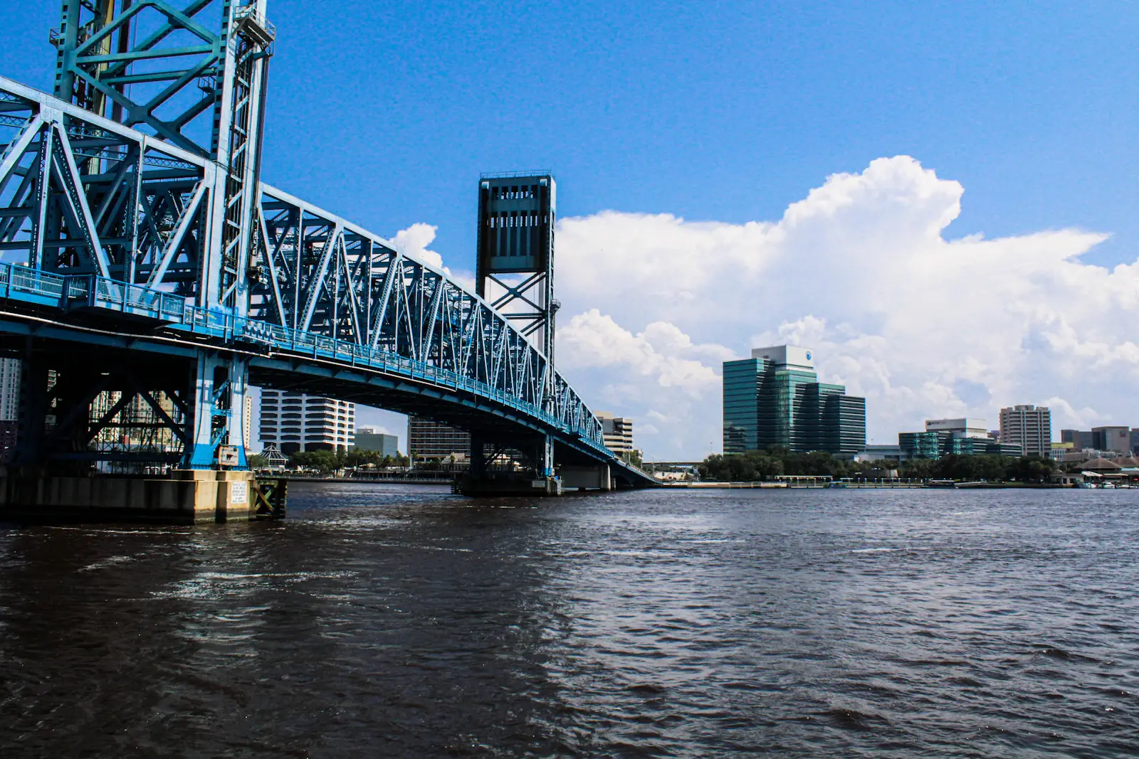 A bridge over the river with the Jacksonville skyline in the background