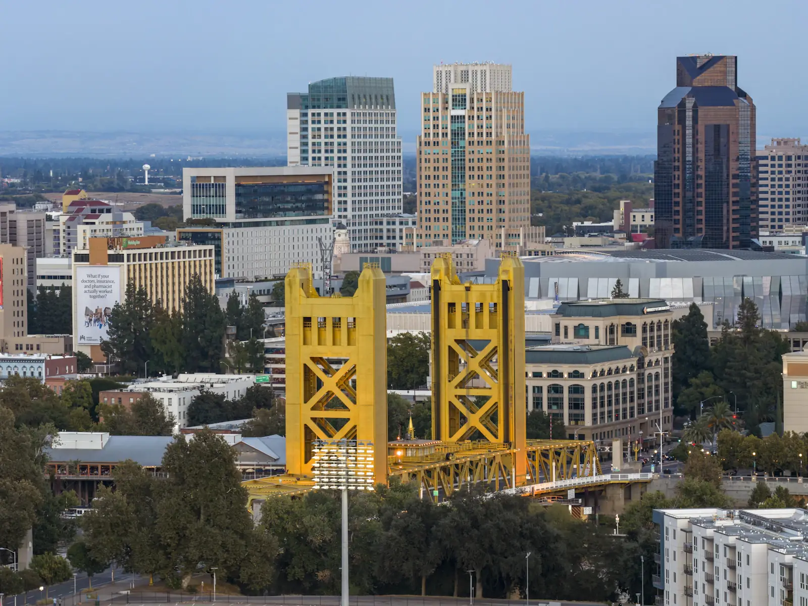 The gold Tower Bridge over the Sacramento River with downtown behind it